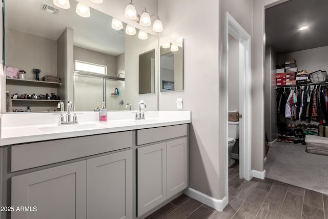 23934 W Verlea Dr, Buckeye, AZ 85326 - full bath featuring toilet, double vanity, wood finish floors, and a spacious closet