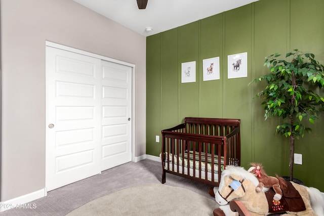 23934 W Verlea Dr, Buckeye, AZ 85326 - bedroom with carpet flooring, a crib, baseboards, a decorative wall, and ceiling fan