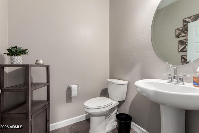 23934 W Verlea Dr, Buckeye, AZ 85326 - bathroom featuring baseboards, toilet, and wood finished floors