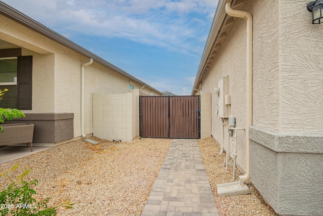 23934 W Verlea Dr, Buckeye, AZ 85326 - view of property exterior with stucco siding and a gate
