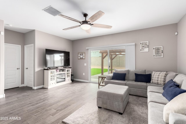 23934 W Verlea Dr, Buckeye, AZ 85326 - living room featuring ceiling fan, wood finished floors, and baseboards