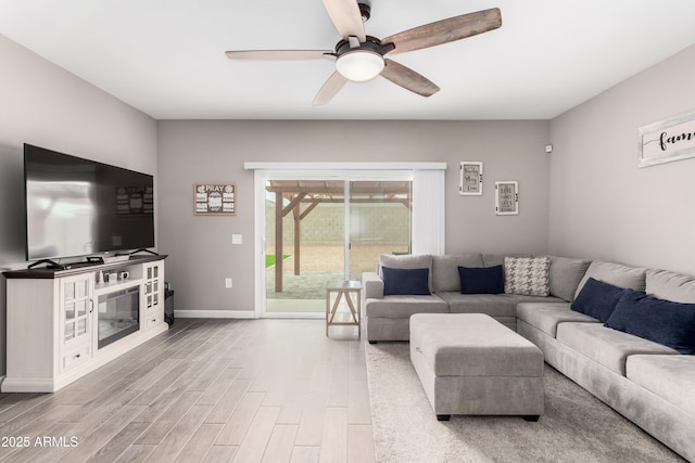 23934 W Verlea Dr, Buckeye, AZ 85326 - living room featuring a ceiling fan, wood finished floors, and baseboards