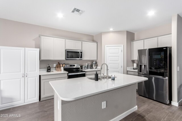 23934 W Verlea Dr, Buckeye, AZ 85326 - kitchen with appliances with stainless steel finishes, a sink, wood finished floors, light countertops, and recessed lighting