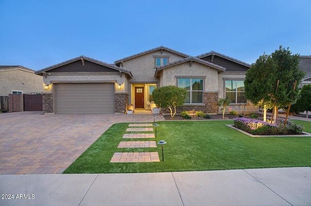 craftsman-style home featuring a front yard and a garage