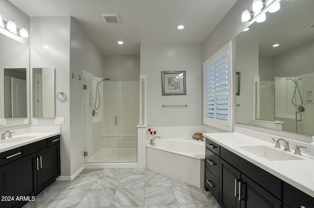 bathroom with vanity and independent shower and bath