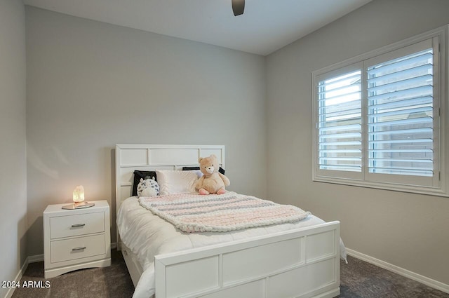 bedroom featuring ceiling fan and dark colored carpet