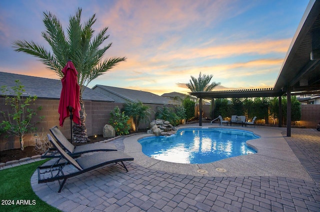 pool at dusk with a patio area and a pergola