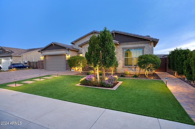 view of front of property featuring a front yard and a garage