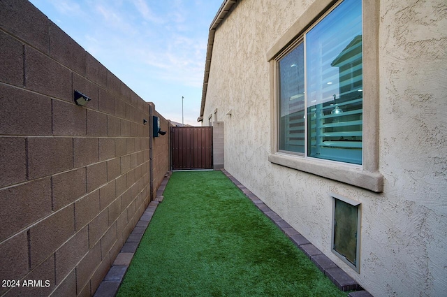 view of side of property with a yard