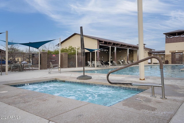 view of swimming pool featuring a community hot tub