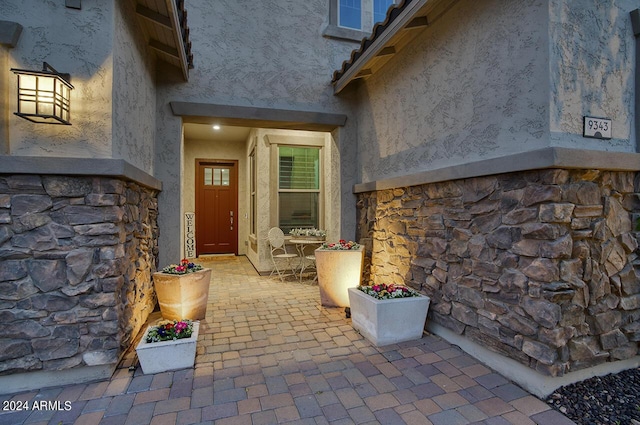 entrance to property with a patio area