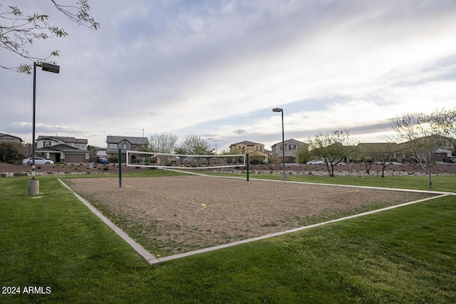 view of home's community with volleyball court and a yard