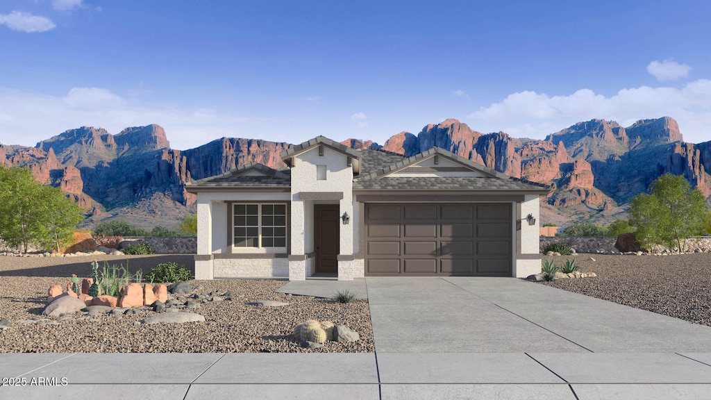 24263 W Southgate Ave, Buckeye, AZ 85326 - view of front of property with a garage, driveway, stucco siding, and a mountain view