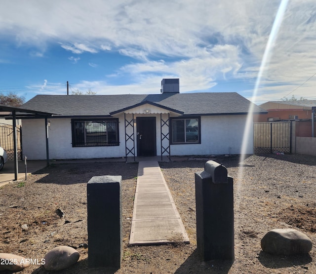 3123 W Holly St, Phoenix, AZ 85009 - view of front facade with fence and a shingled roof
