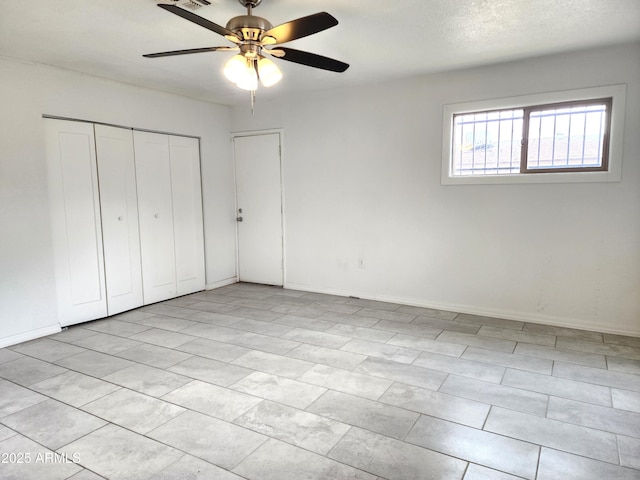 3123 W Holly St, Phoenix, AZ 85009 - unfurnished bedroom with a closet, baseboards, and a ceiling fan