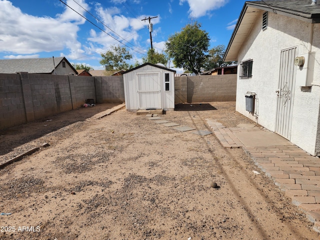 3123 W Holly St, Phoenix, AZ 85009 - view of yard featuring a fenced backyard, an outdoor structure, and a shed