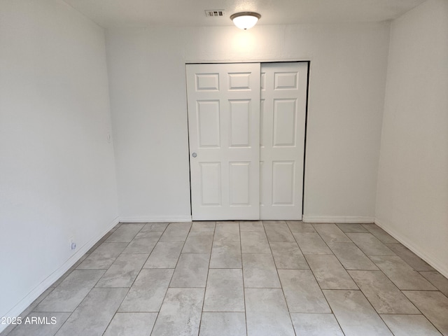 3123 W Holly St, Phoenix, AZ 85009 - unfurnished bedroom with baseboards, visible vents, and a closet