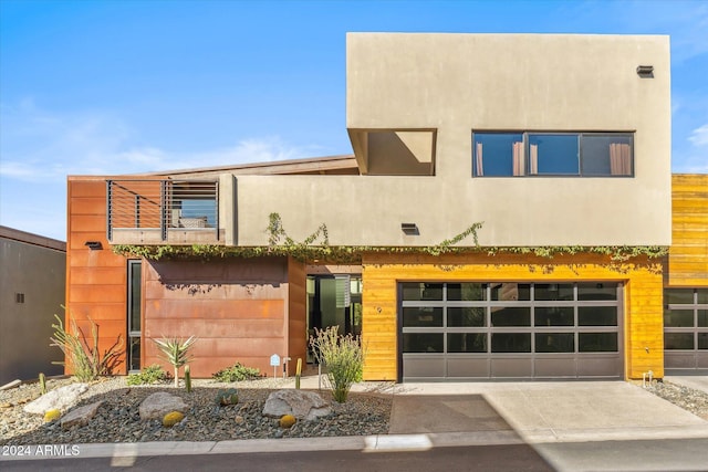 modern home with a balcony and a garage