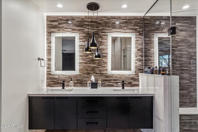 bathroom with vanity, an enclosed shower, and tasteful backsplash