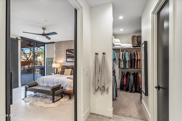 carpeted bedroom featuring access to outside, ceiling fan, a closet, and a wall of windows