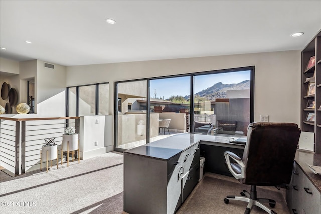 home office featuring a mountain view, carpet, and vaulted ceiling