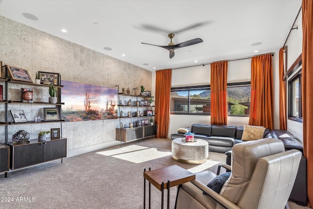 carpeted living room with ceiling fan