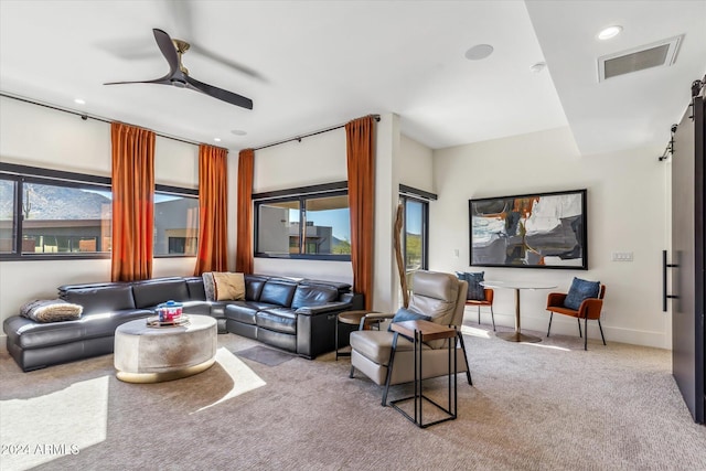 carpeted living room with ceiling fan