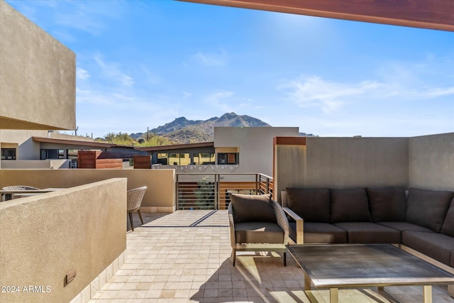 balcony featuring a mountain view and an outdoor living space