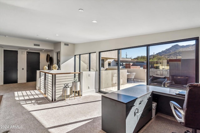 carpeted home office featuring a mountain view