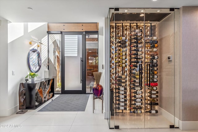 wine cellar with tile patterned flooring and electric panel