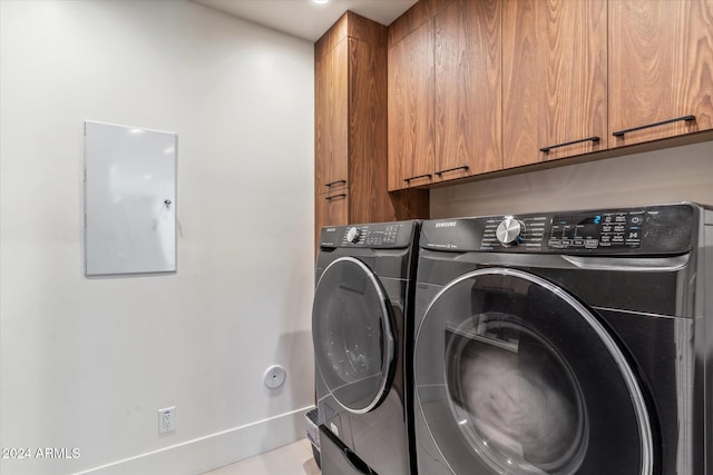 laundry room featuring cabinets and separate washer and dryer