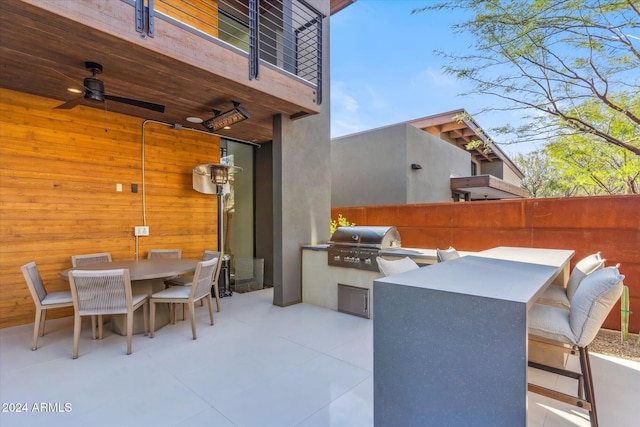 view of patio featuring an outdoor kitchen, ceiling fan, a balcony, and grilling area