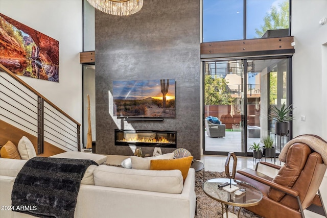 living room with a towering ceiling and a large fireplace