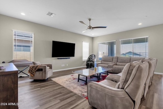 living room featuring plenty of natural light, light wood-style flooring, and baseboards