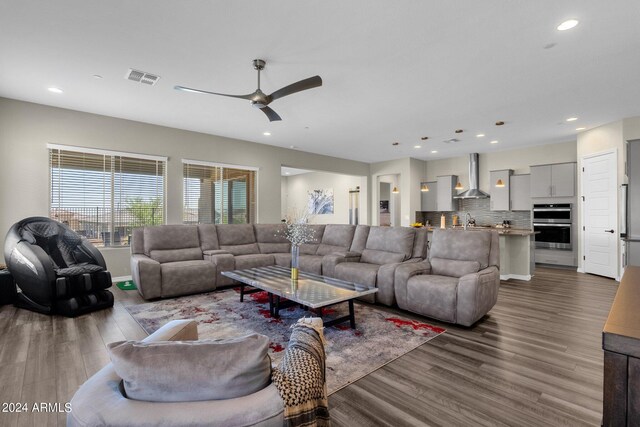 living room with ceiling fan and hardwood / wood-style flooring