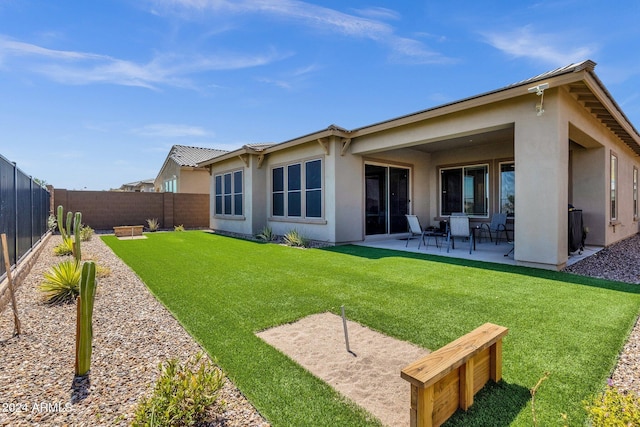 back of house with a fenced backyard, a patio, and stucco siding