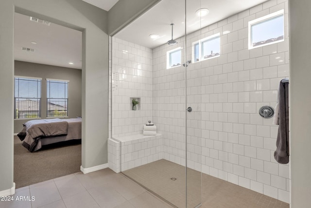 ensuite bathroom with a walk in shower, tile patterned flooring, connected bathroom, and visible vents