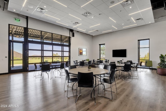 dining room featuring a high ceiling, wood finished floors, and visible vents