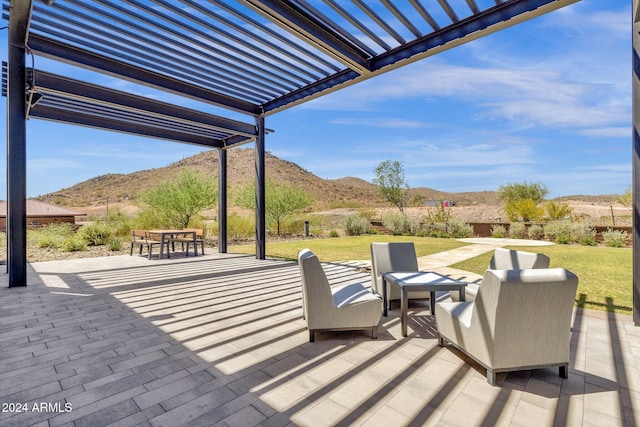 view of patio / terrace with a mountain view, outdoor dining area, and a pergola