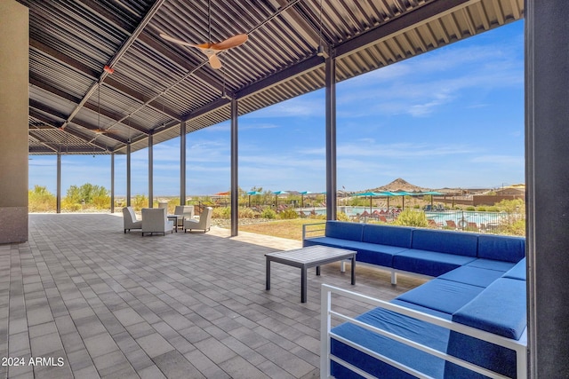 view of patio / terrace with a water view, ceiling fan, and an outdoor hangout area