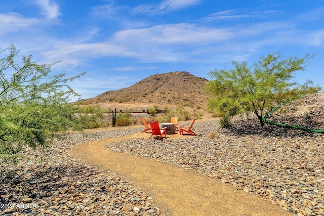 view of yard featuring a fire pit and a mountain view