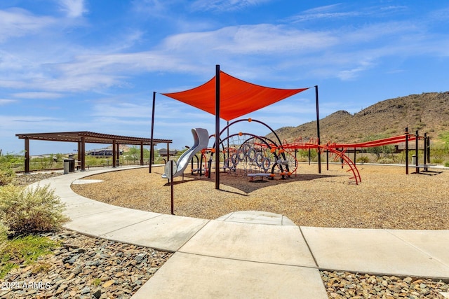 communal playground featuring a mountain view