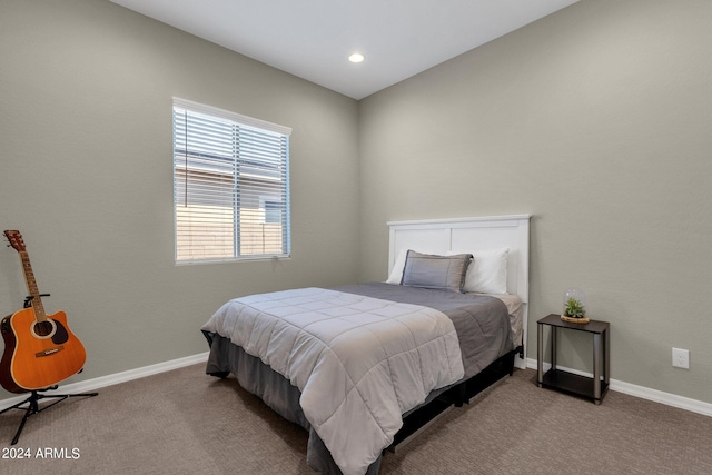 bedroom with baseboards and light colored carpet