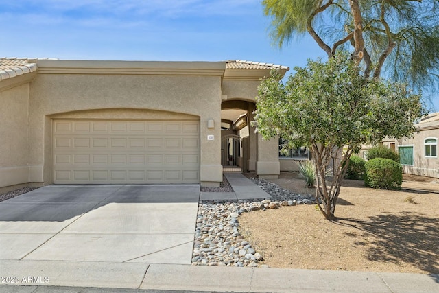 view of front of home with a tiled roof, a garage, and stucco siding