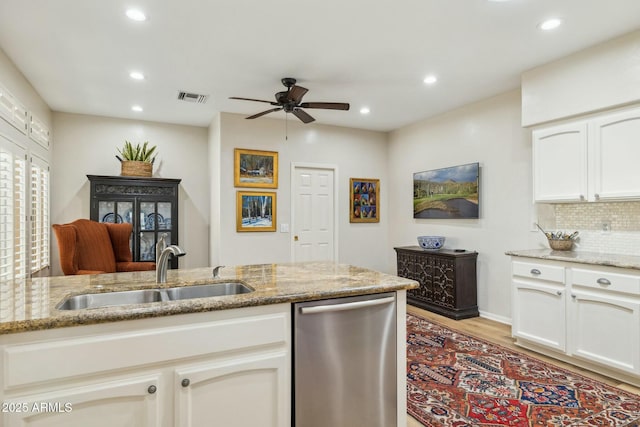kitchen featuring visible vents, light stone countertops, a ceiling fan, a sink, and stainless steel dishwasher