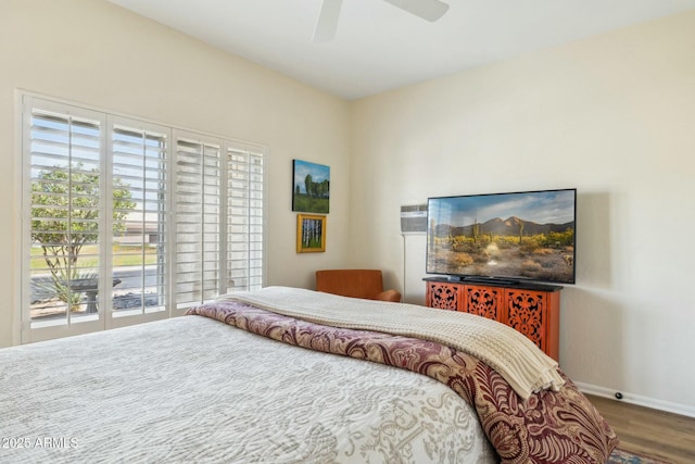 bedroom featuring baseboards, access to exterior, wood finished floors, and a ceiling fan