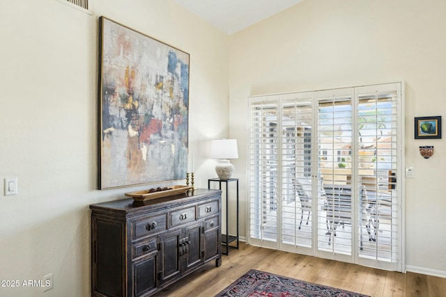 interior space featuring baseboards and wood finished floors
