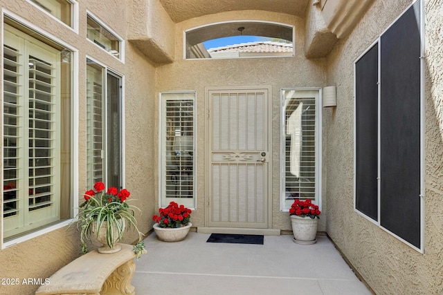 doorway to property with stucco siding