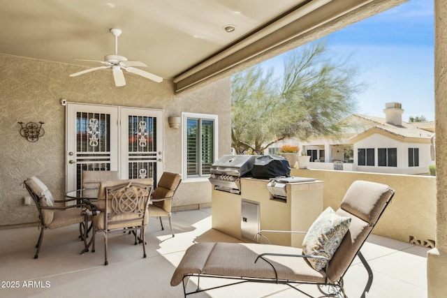 view of patio / terrace featuring outdoor dining space, area for grilling, and a ceiling fan