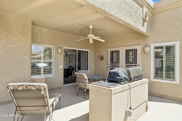 view of patio / terrace featuring grilling area, exterior kitchen, and ceiling fan